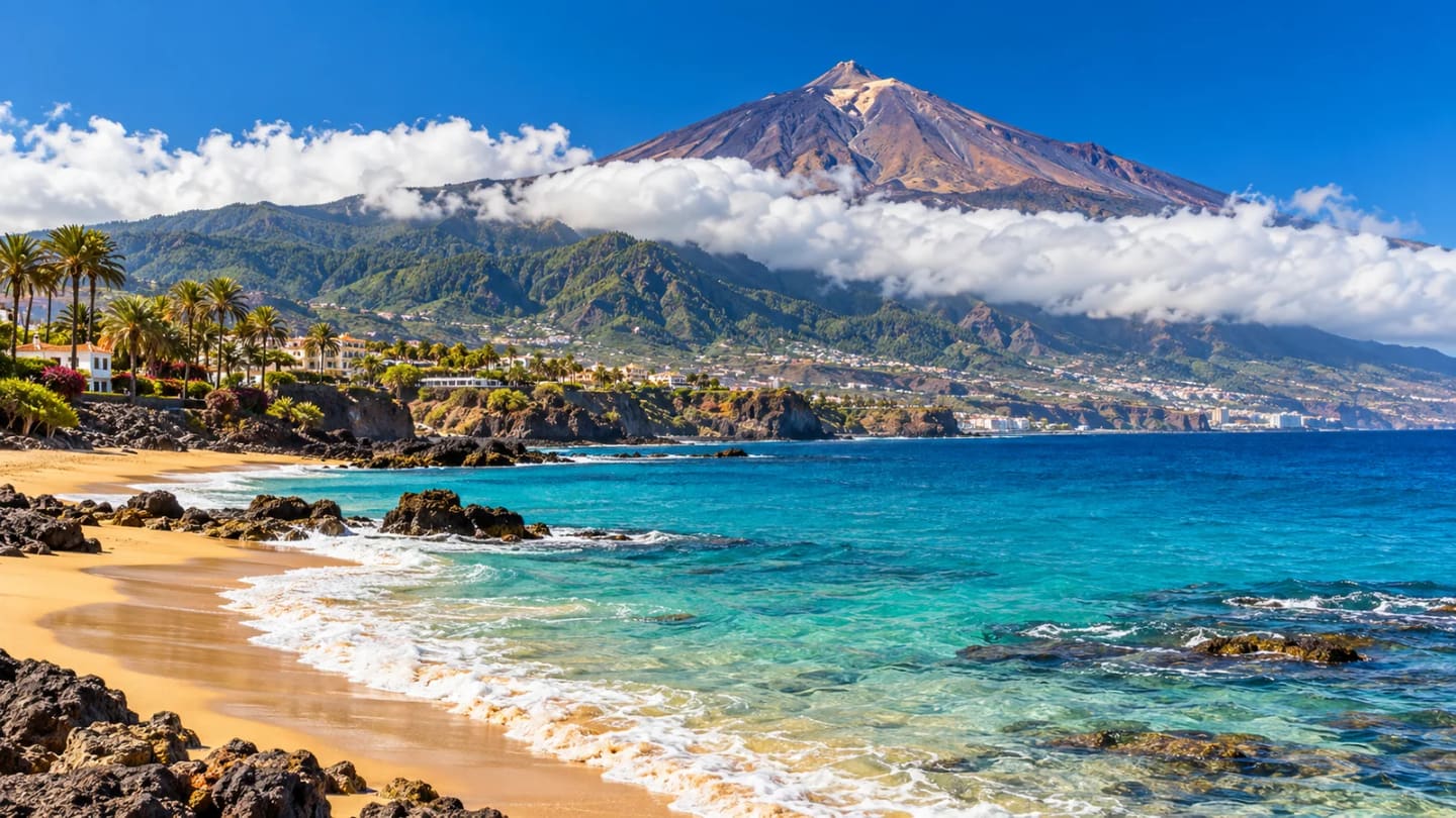 Sunlit Tenerife coast, a cloud belt and Mount Teide
