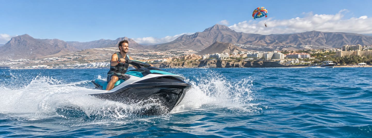 Jet ski rider on the Atlantic off Costa Adeje with Tenerife’s volcanic coast behind him