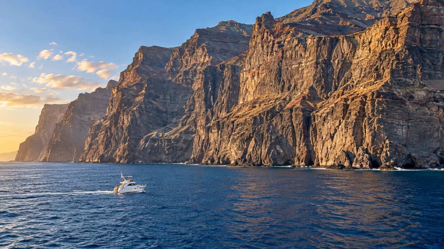 High Los Gigantes volcanic cliffs above the Atlantic with a small boat below