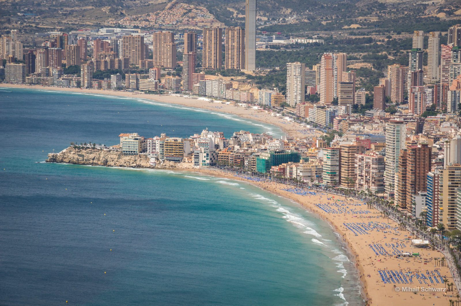 In the foreground is Levante beach, behind the ledge is Poniente beach